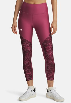 Höga, avslutade leggings i ett djupt rosa tyg med ett texturerat vinrött mönster längs nedre delarna av benen. Har ett slätt, stretchigt material.