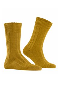Calze di cotone giallo dorato con texture a coste, lunghezza alla caviglia, tallone e punta rinforzati, finitura liscia, caratterizzate da sottili linee verticali.