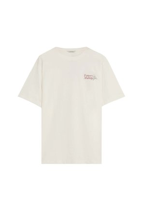 Camiseta crema de manga corta con texto "Fabricación de cerámica" y un pequeño gráfico de un torno de alfarero en el área del pecho izquierdo.