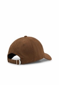 Brown corduroy cap with a curved brim and an adjustable strap at the back. Features vertical ribbed texture and a small logo detail.
