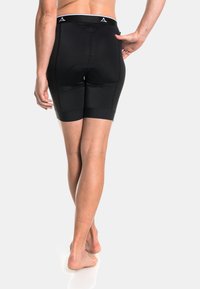 Schwarze Kompressionsshorts aus dehnbarem Material mit glatter Oberfläche, elastischem Bund und Netzpaneelen für Atmungsaktivität.