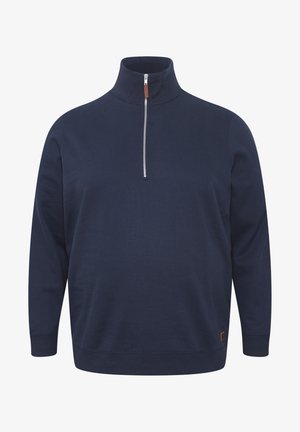 Tume mere pullover kõrge kaeluse ja pool tõmblukuga. Valmistatud pehmest kangast, millel on pikad varrukad ja külgmine servade detail.