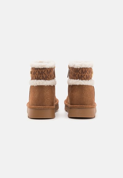 Brown suede ankle boots with white fur trim, featuring a patterned brown band and a zipper on the side. Flat rubber sole.