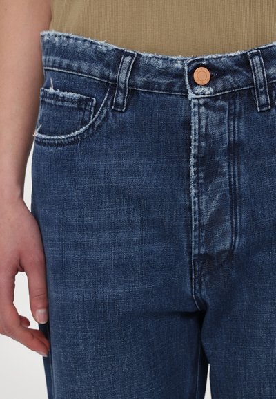 Denim jeans with a faded blue color, frayed waistband, and classic five-pocket design. Includes a brass button closure and loose-fitting style.