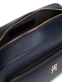 Navy leather bag with dual gold zippers and a textured accent pocket. Features a logo detail and a smooth finish. Interior view shown.