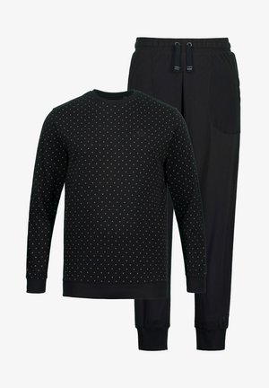 Completo di abbigliamento da casa nero con maglietta a maniche lunghe con motivo a pois bianchi e pantaloni abbinati con vita elastica e polsini.