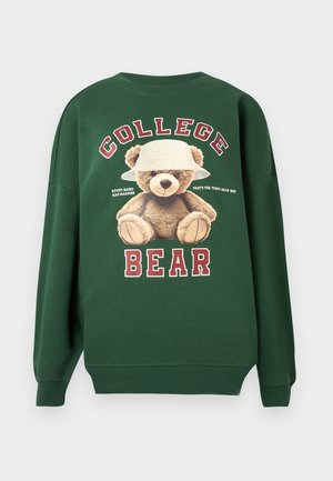 Tume roheline sviiter, millel on karu valge mütsiga, tekst "KOLLEDŽ" karu kohal ja "KARU" all.