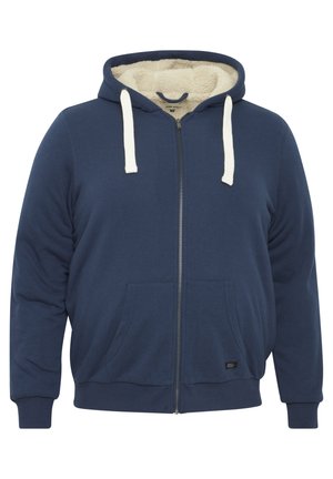 Tummansininen vetoketjullinen huppari, jossa on pehmeä kermahohtoinen vuori, etutaskut ja erottuva naru. Pehmeä kangas, rento istuvuus, ribbineuleiset hihansuut.