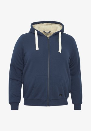 Tumesinine tõmblukuga jakki, millel on pehme kreemjas vooder, esikülje taskud ja kontrastne pael. Pehme kangas, mugav lõike, soonikkoes mansetid.