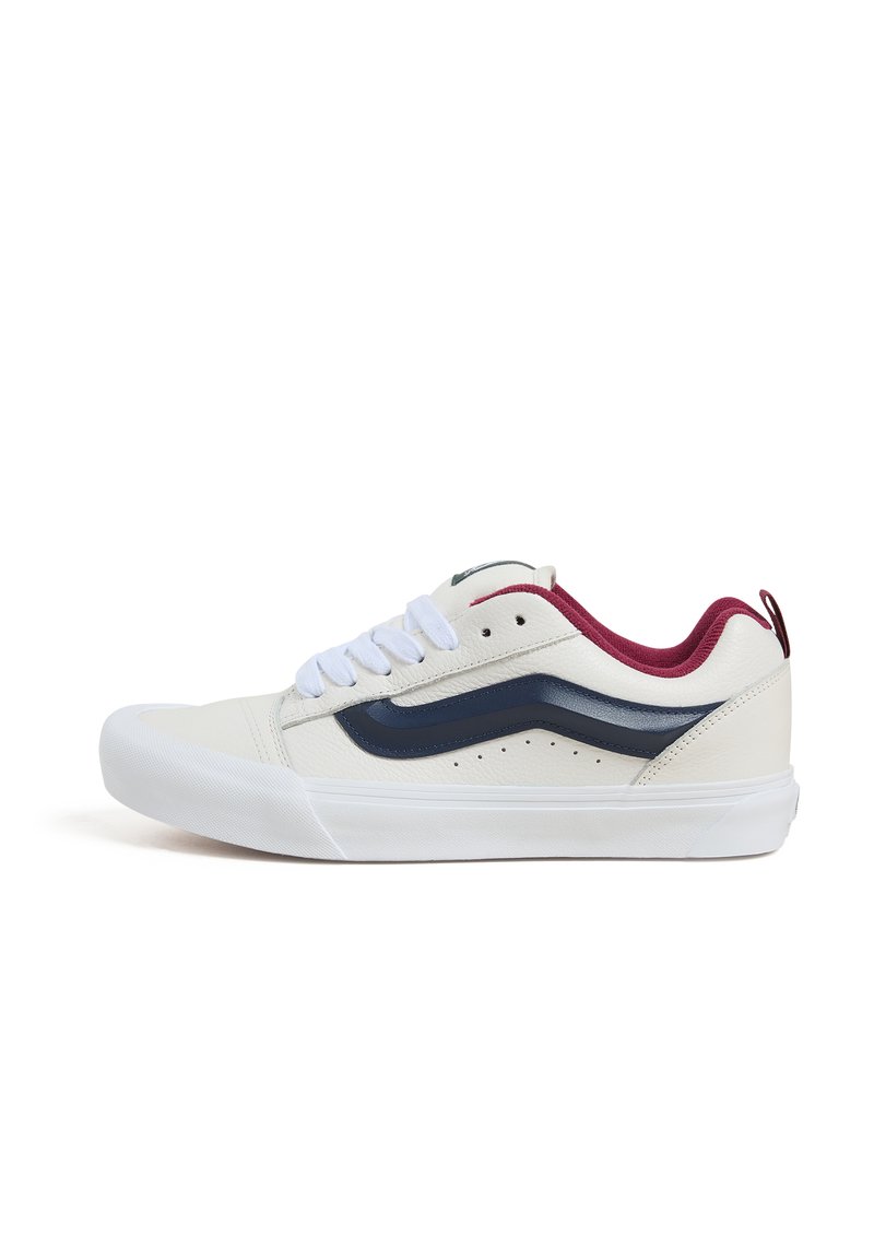 Hvide lædersneakers med marineblå sidelinje, bordeauxfarvede kraveaccentuer, hvide snørebånd og tekstureret gummisål. Sideprofilvisning.