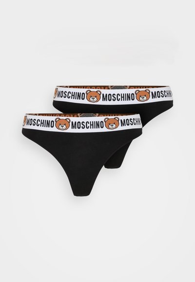 Cotton thong underwear in black, featuring a white waistband with a brown bear graphic and "MOSCHINO" text. Smooth texture, minimalist design.