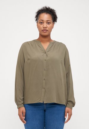 Olive green long-sleeve blouse with a V-neck, button front, and loose fit. Smooth fabric with a slight sheen. Slightly curved hem.