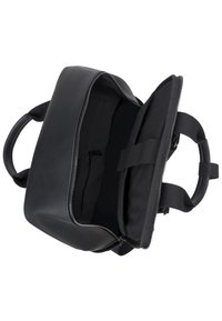 Black leather bag with a zippered opening, featuring a smooth exterior, robust handles, and a spacious, lined interior with a zip pocket.