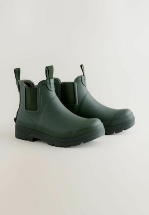 Grüne Gummistiefeletten mit elastischen Seitenteilen, strukturierten Sohlen und Zuglaschen. Mattes Finish, robustes Design für den Außeneinsatz.