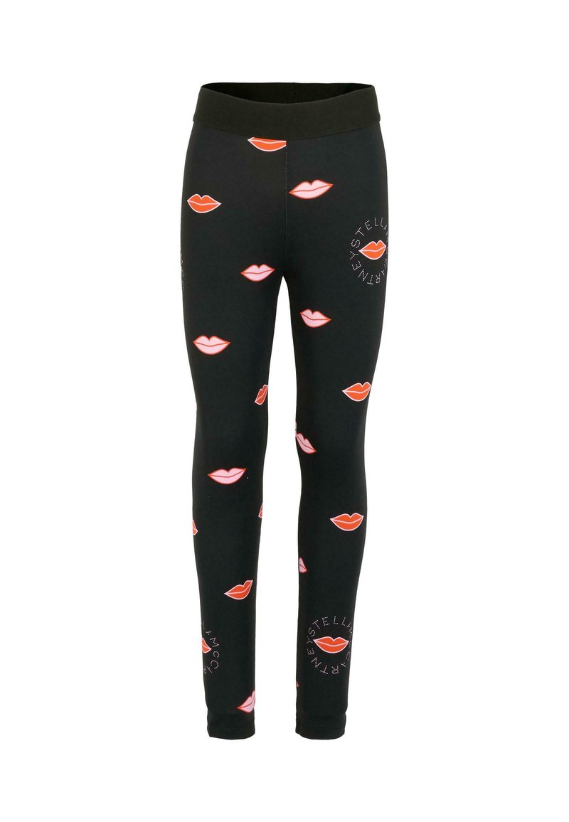 Leggings noirs avec un motif répétitif de lèvres rouges et roses, avec un logo imprimé en blanc sur le bas de la jambe. Tissu lisse et extensible.