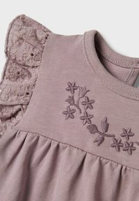 Bomuldskjole i støvet mauve med blomsterbroderi, volangærmere i lace og en plisseret nederdel. Blød tekstur og tætsiddende halsudskæring.