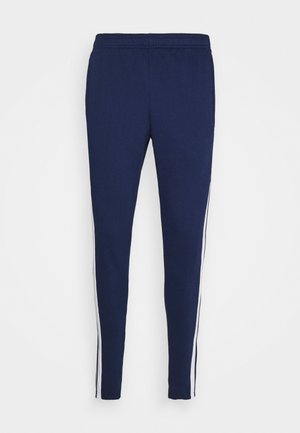Marineblaue Slim-Fit-Hose mit elastischem Bund und weißen Seitenstreifen, entworfen für Freizeit- oder Sportbekleidung.