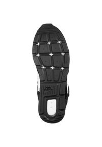 Black rubber sneaker sole with rectangular and star-shaped treads, featuring a white accent, textured surface, and 'Nike' branding.