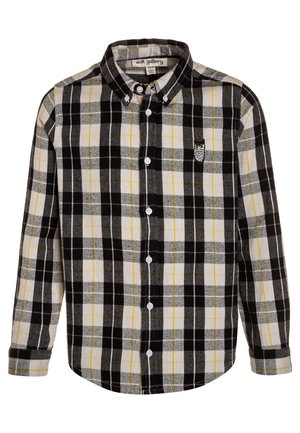 Koszula w kratę w kolorach czarnym, szarym i żółtym, wykonana z flaneli; posiada kołnierzyk zapinany na guziki, długie rękawy oraz haft sowy.