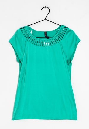 Turquoise short-sleeve blouse with pleated decorative neckline, hanging on a black hanger against a white background.