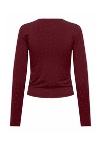 Bordowa dopasowana bluzka z długim rękawem w drobne, równomiernie rozmieszczone białe kropki, widoczna od tyłu.