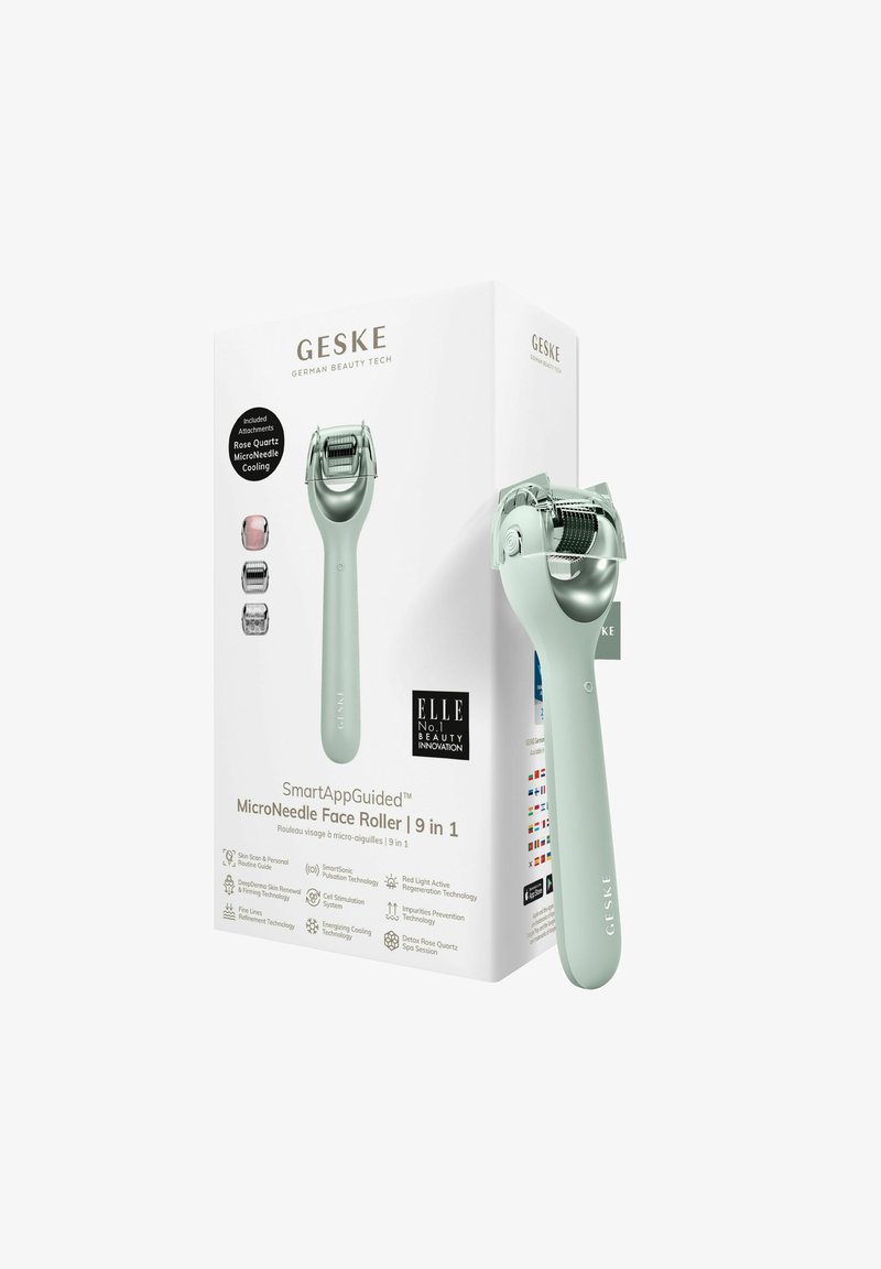 Rullo per il viso a microago con manico verde chiaro, testa in acciaio inossidabile e superficie di rotolamento testurizzata. La scatola include vari accessori.