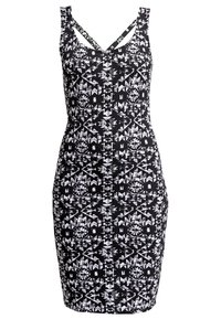 Robe ajustée sans manches noire et blanche avec des motifs tribaux géométriques et des bretelles doubles formant un décolleté en V.