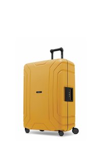 Valigia rigida di colore giallo brillante con superficie testurizzata. Dotata di manico retraibile, lucchetto a combinazione e quattro ruote per una facile mobilità.