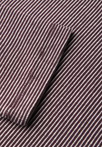Cotton fabric with alternating dark burgundy and white vertical stripes, featuring a textured surface and clean edge detailing.