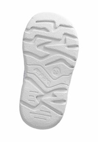 Suola in gomma bianca di una scarpa per bambini con un motivo di battistrada a zigzag e lineare e il numero di taglia 20 impresso vicino al centro.