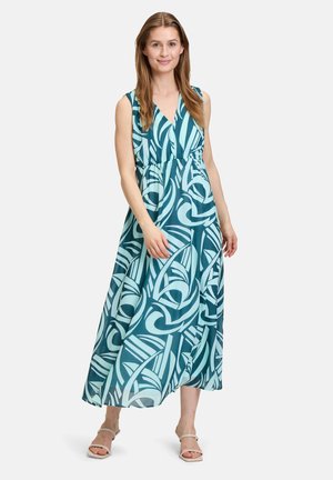 Maxikleid in Teal mit weißen abstrakten Mustern, V-Ausschnitt, ärmellosem Design, geraffter Taille und fließendem Stoff.