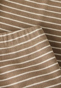 Brown ribbed fabric with white horizontal stripes, displaying a soft texture and a close-up view of the stitching and hem details.