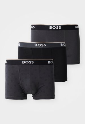 Drei Paar Boxershorts in verschiedenen Schwarz- und Grautönen. Mit einem markierten Bund und einem dezenten Muster bei einem Paar.