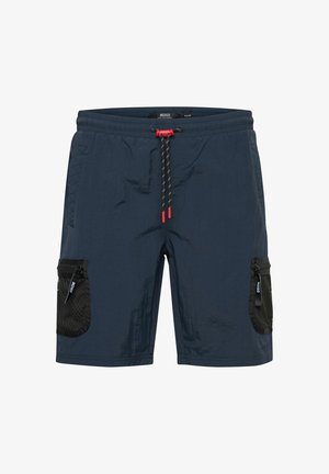 Mørkeblå shorts med struktureret overflade, der har rød snor i taljen, sidelommer i mesh og lynlåsdetaljer til opbevaring.