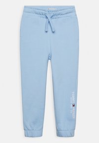 Lyseblå sweatpants med elastisk talje og snøre. Har sidelommer og broderet "Tommy Hilfiger" logo på benet.