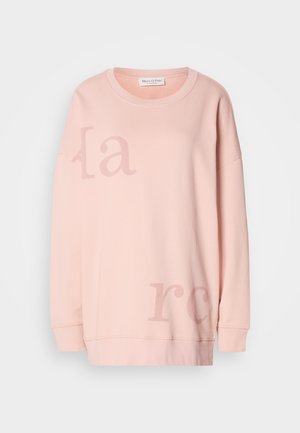 Lichtroze sweatshirt met een ronde hals, lange mouwen en grote vervaagde tekst op de voorkant. Zachte katoen met een relaxte pasvorm.
