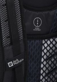 Black mesh harness from Jack Wolfskin featuring adjustable height mechanism. Notable texture with diamond pattern and branded label.