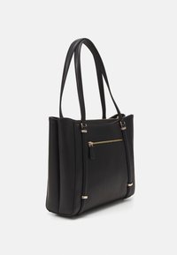 Black leather tote bag with dual top handles, featuring a front zip pocket and gold hardware accents. Smooth texture and structured design.