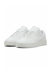 White sneakers with a smooth synthetic upper, textured side panel, and a thick rubber sole. Features laces and padded tongue for comfort.