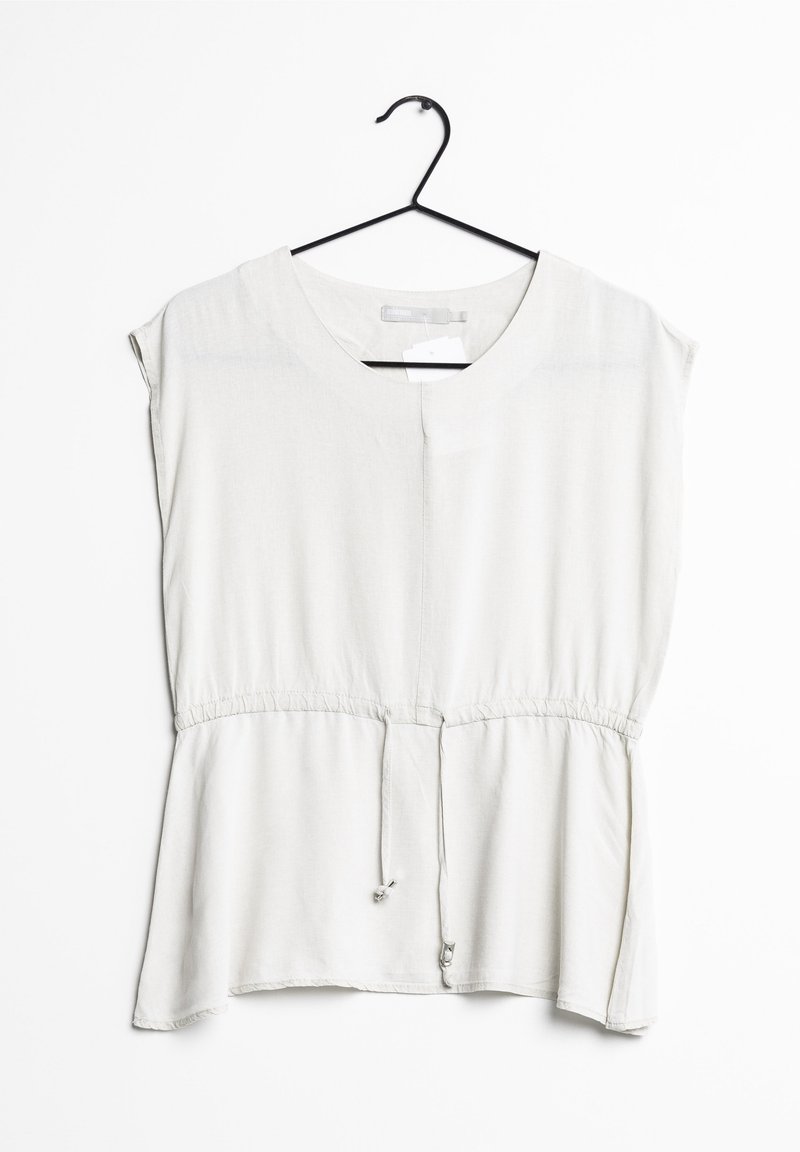 Haut gris clair à manches courtes avec une coupe ample, taille cintrée, encolure arrondie et un détail à nouer à l'ourlet. Texture douce et design simple.
