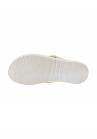 Sole in gomma bianca con superficie testurizzata e grip a motivo. Presenta scanalature per flessibilità. Accenti circolari semplici lungo il bordo.