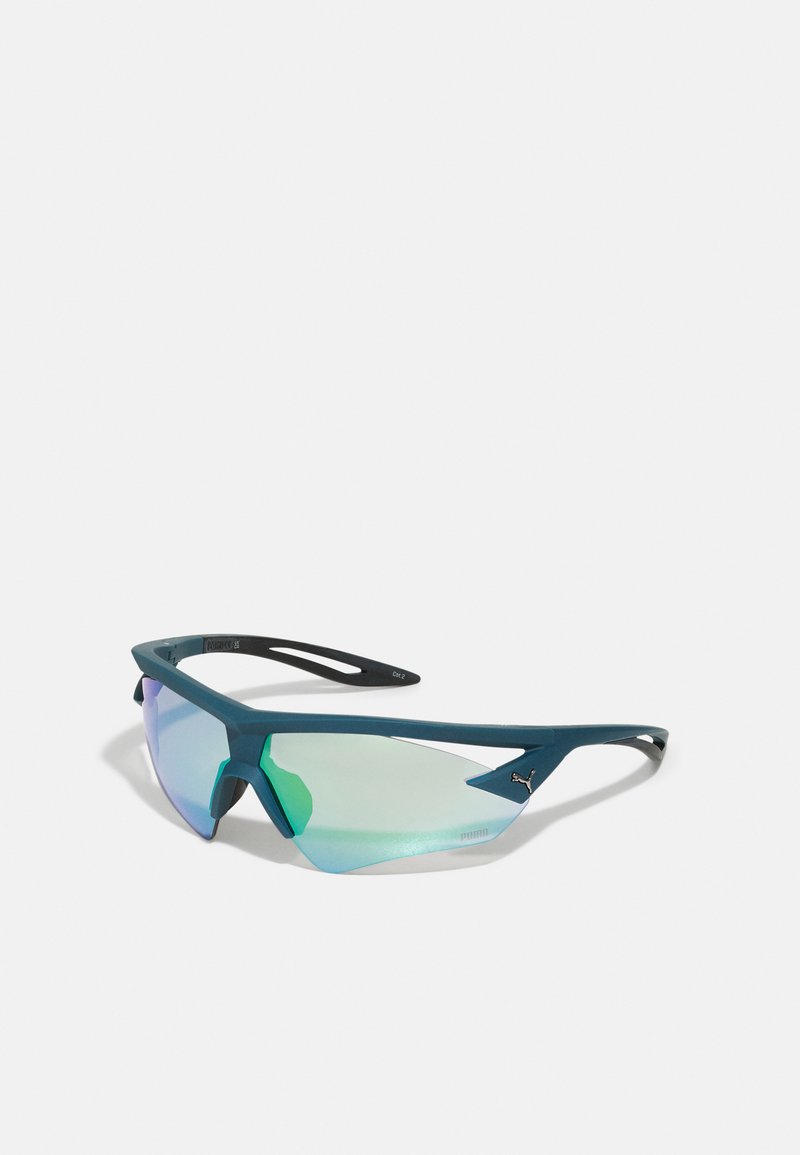 Lunettes de sport avec une monture angulaire, de couleur teal, et des verres réfléchissants verts. Design léger avec des branches fines et flexibles.