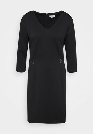 Vestido negro con escote en V, mangas largas y dos bolsillos con cremallera en la parte frontal. Hecho de tejido suave con una silueta ajustada.