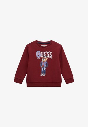 Felpa bordeaux con maniche lunghe, polsini e scollatura a coste; presenta una grafica di un orso che indossa un giubbotto, accompagnata dal testo "GUESS".