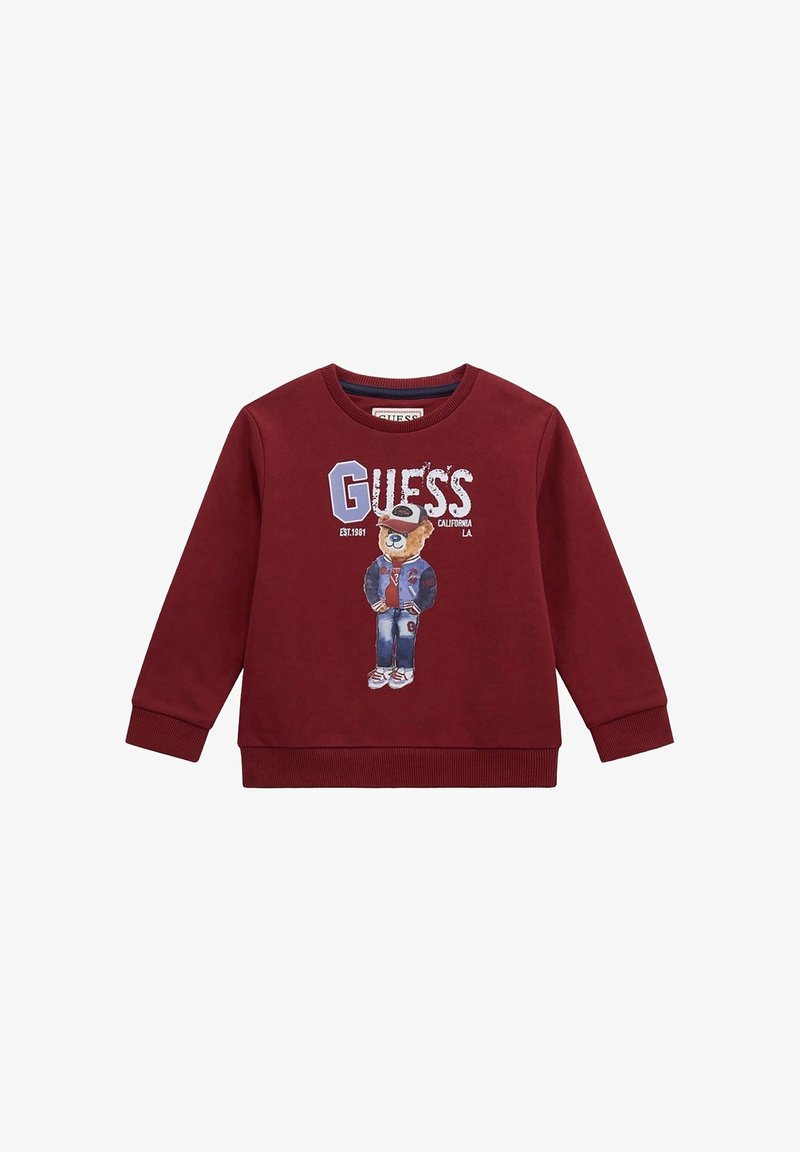 Felpa bordeaux con maniche lunghe, polsini e scollatura a coste; presenta una grafica di un orso che indossa un giubbotto, accompagnata dal testo "GUESS".