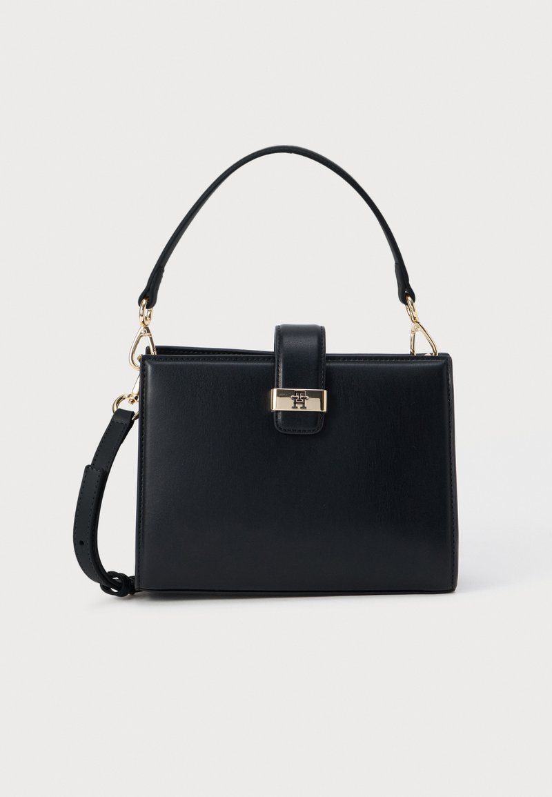Black rectangular handbag with top handle and detachable shoulder strap, featuring a gold-tone clasp closure with a logo detail.
