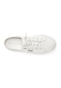 White canvas sneaker with laces, round toe, and rubber sole. Features subtle branding and textured stitching details.