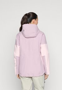 Lys lilla jakke med hette og rosa ermer, med en glatt tekstur og en litt løs passform. Ingen synlige lukkinger eller detaljer på baksiden.