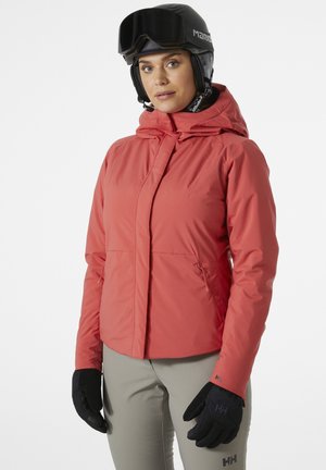 Red ski jacket with a hood, side pockets, and adjustable cuffs, paired with black gloves. Model wears a ski helmet and goggles.