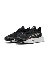 Czarne buty sportowe z oddychającą siateczką, kontrastującą białą podeszwą i różowymi akcentami. Posiadają teksturowany uchwyt na podeszwie.